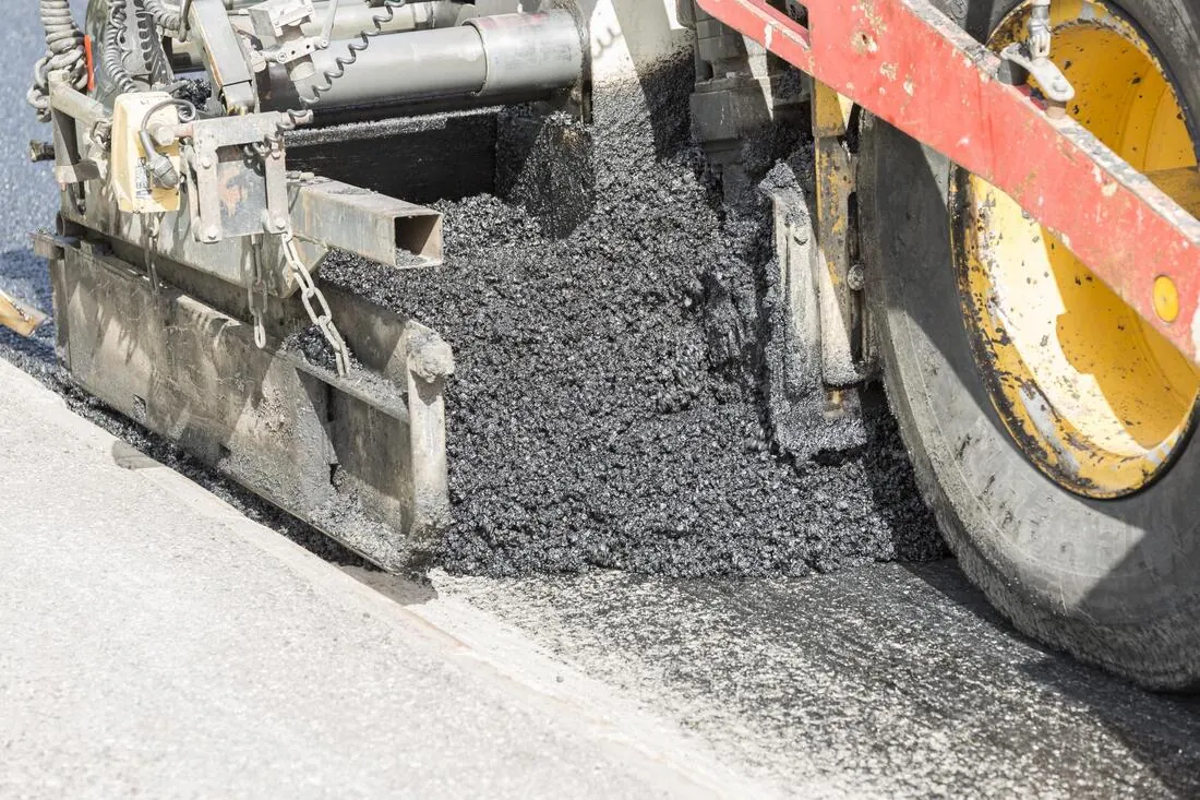 Road paving machine laying asphalt